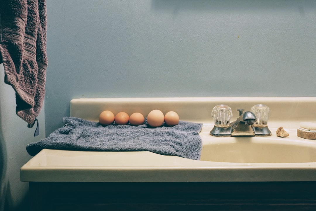 gentle skincare routine essentials arranged on a clean bathroom counter with cleanser, moisturizer, and a folded towel