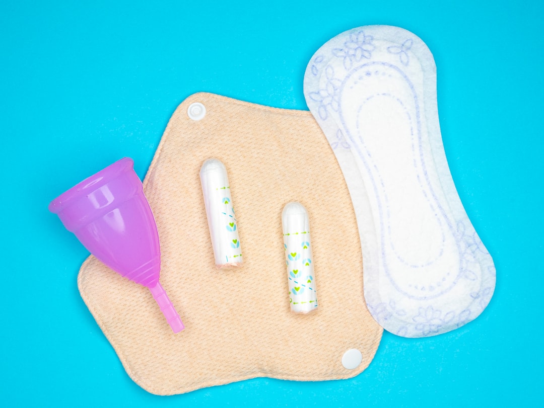 menstrual self care routine cover illustration showing a calendar, cup of herbal tea, soft heat pad, and breathable clothing for period comfort